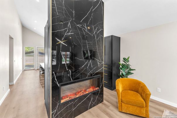Fireplace, Interior, Marble Walls, Recessed Lighting, Wood Texture Flooring