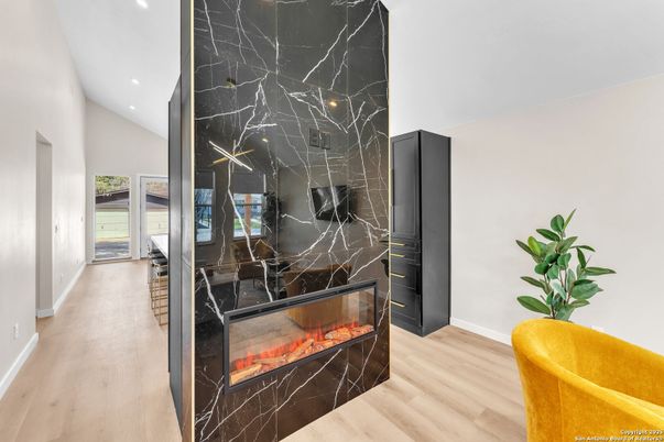 Fireplace, Interior, Marble Walls, Recessed Lighting, Wood Texture Flooring