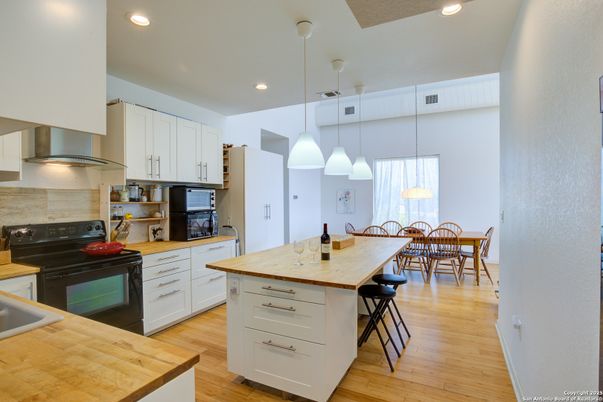 Dining room, Interior, Kitchen, Pendant Lights, Recessed Lighting, Stainless Steel Appliances, Wood Texture Flooring