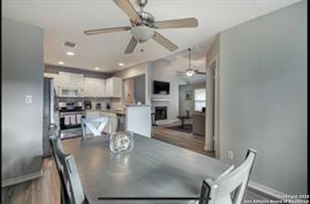 Dining room, Fireplace, Interior, Kitchen, Recessed Lighting, Stainless Steel Appliances, Wood Texture Flooring