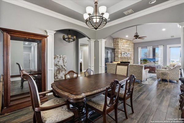 Chandelier, Dining room, Fireplace, Interior, Living room, Recessed Lighting, Stone Walls, Wood Texture Flooring
