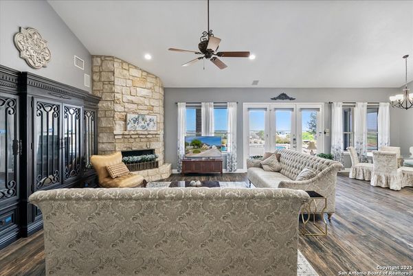 Chandelier, Dining room, Fireplace, Interior, Living room, Recessed Lighting, Stone Walls, Wood Texture Flooring