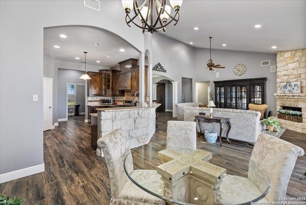 Chandelier, Dining room, Fireplace, Interior, Kitchen, Living room, Pendant Lights, Recessed Lighting, Stone Walls, Wood Texture Flooring