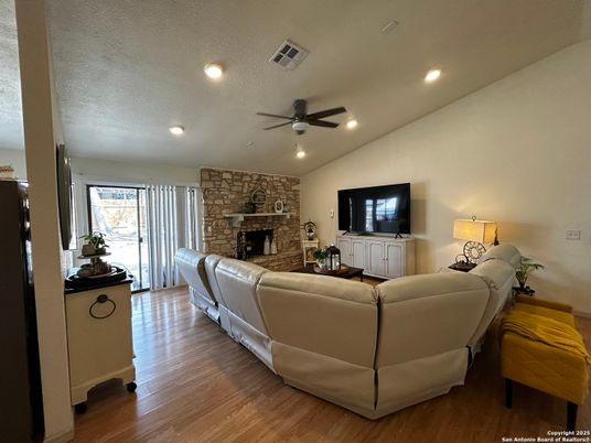 Fireplace, Interior, Living room, Recessed Lighting, Stone Walls, Wood Texture Flooring