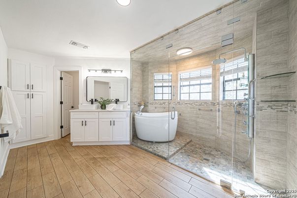 Bathroom, Dual Sink Vanities, Free Standing Baths, Glass Shower, Interior, Recessed Lighting, Wood Texture Flooring