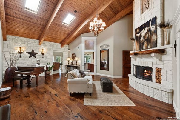 Chandelier, Fireplace, Interior, Living room, Piano, Stone Walls, Wooden Beams, Wooden Ceilings, Wood Texture Flooring