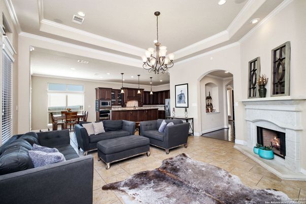 Chandelier, Dining room, Fireplace, Interior, Kitchen, Living room, Pendant Lights, Recessed Lighting, Stainless Steel Appliances