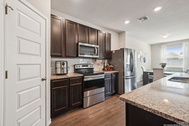 Dining room, Interior, Kitchen, Recessed Lighting, Stainless Steel Appliances, Wood Texture Flooring