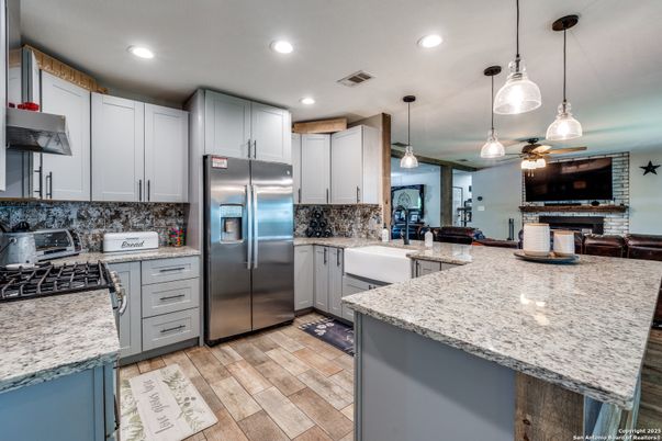 Fireplace, Interior, Kitchen, Pendant Lights, Recessed Lighting, Stainless Steel Appliances, Wood Texture Flooring