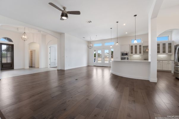 Empty room, Interior, Kitchen, Pendant Lights, Recessed Lighting, Stainless Steel Appliances, Wood Texture Flooring