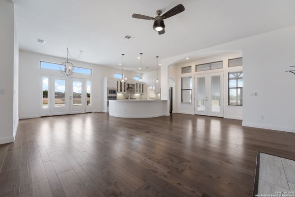 Chandelier, Empty room, Interior, Kitchen, Pendant Lights, Recessed Lighting, Stainless Steel Appliances, Wood Texture Flooring