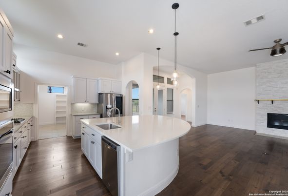 Fireplace, Interior, Kitchen, Pendant Lights, Recessed Lighting, Stainless Steel Appliances, Wood Texture Flooring