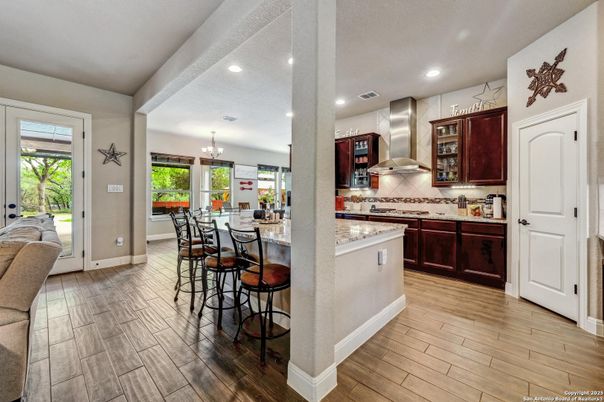 Chandelier, Dining room, Interior, Kitchen, Recessed Lighting, Stainless Steel Appliances, Wood Texture Flooring