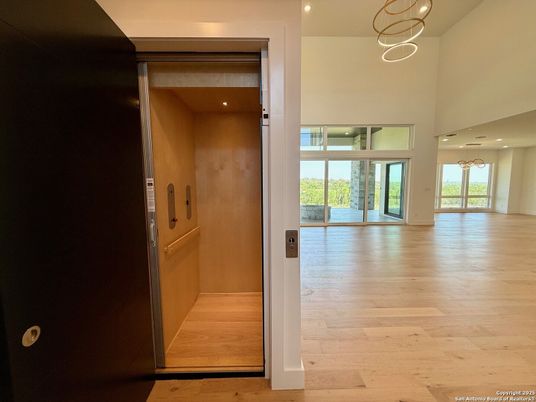 Elevator, Interior, Pendant Lights, Recessed Lighting, Wood Texture Flooring, Wooden Walls