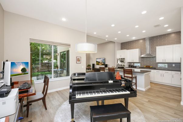 Dining room, Interior, Kitchen, Pendant Lights, Piano, Recessed Lighting, Stainless Steel Appliances, Wood Texture Flooring