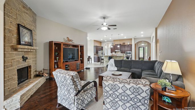 Fireplace, Interior, Kitchen, Living room, Pendant Lights, Recessed Lighting, Stainless Steel Appliances, Stone Walls, Wood Texture Flooring