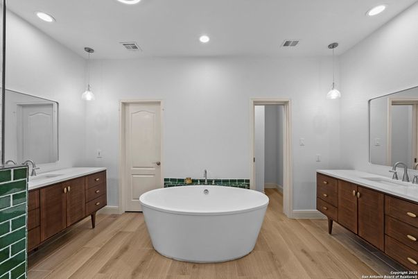 Bathroom, Dual Sink Vanities, Free Standing Baths, Interior, Pendant Lights, Recessed Lighting, Wood Texture Flooring