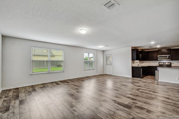 Empty room, Interior, Kitchen, Recessed Lighting, Stainless Steel Appliances, Wood Texture Flooring