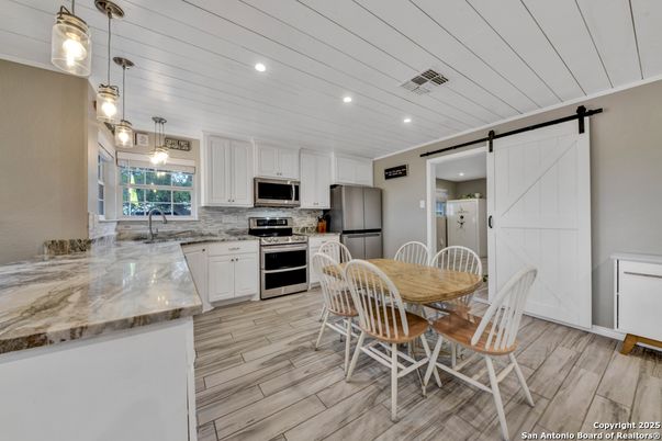 Dining room, Interior, Kitchen, Pendant Lights, Recessed Lighting, Stainless Steel Appliances, Wood Texture Flooring