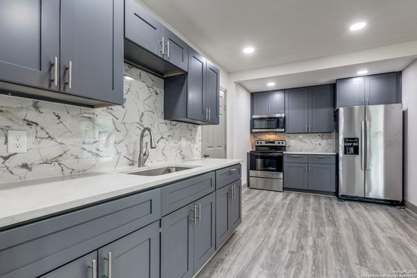 Interior, Kitchen, Marble Walls, Recessed Lighting, Stainless Steel Appliances, Wood Texture Flooring