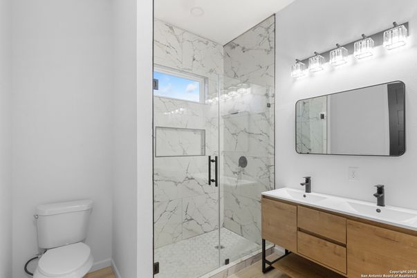 Bathroom, Dual Sink Vanities, Glass Shower, Interior, Marble Walls, Wood Texture Flooring