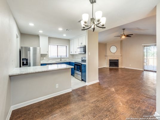 Chandelier, Empty room, Fireplace, Interior, Kitchen, Recessed Lighting, Wood Texture Flooring
