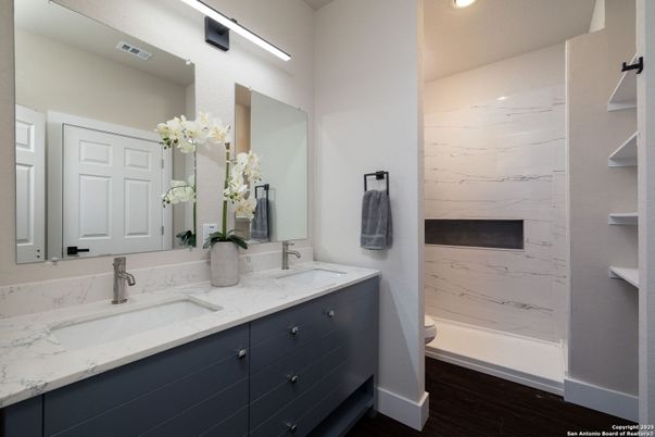 Bathroom, Dual Sink Vanities, Interior, Marble Walls, Recessed Lighting, Wood Texture Flooring