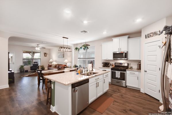 Dining room, Interior, Kitchen, Pendant Lights, Recessed Lighting, Stainless Steel Appliances, Wood Texture Flooring