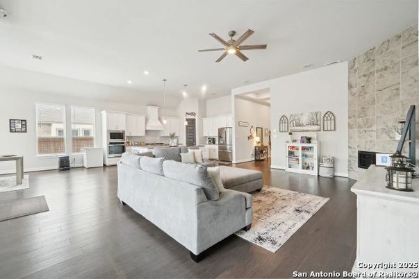 Fireplace, Interior, Kitchen, Living room, Pendant Lights, Recessed Lighting, Stainless Steel Appliances, Stone Walls, Wood Texture Flooring