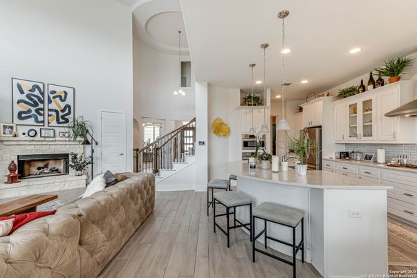 Fireplace, Interior, Kitchen, Living room, Pendant Lights, Recessed Lighting, Stainless Steel Appliances, Wood Texture Flooring