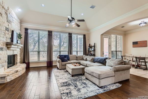 Dining room, Fireplace, Interior, Living room, Recessed Lighting, Stone Walls, Wood Texture Flooring