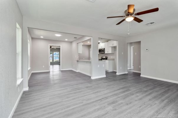 Empty room, Interior, Kitchen, Recessed Lighting, Stainless Steel Appliances, Wood Texture Flooring