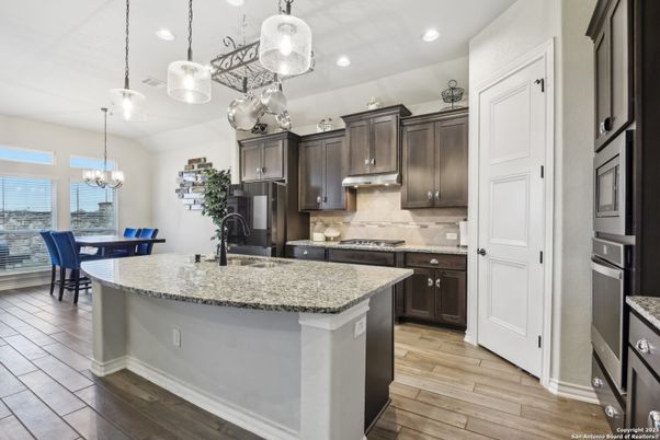 Chandelier, Dining room, Interior, Kitchen, Pendant Lights, Recessed Lighting, Stainless Steel Appliances, Wood Texture Flooring