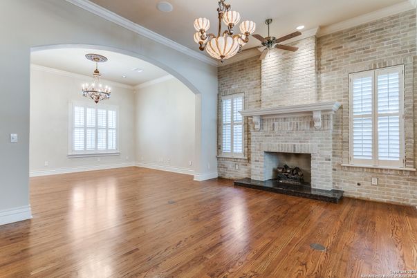 Chandelier, Empty room, Fireplace, Interior, Recessed Lighting, Stone Walls, Wood Texture Flooring
