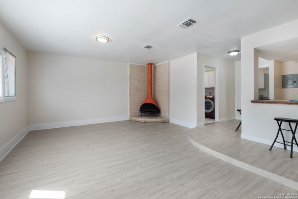 Empty room, Fireplace, Interior, Utility Closets, Washer, Wood Texture Flooring