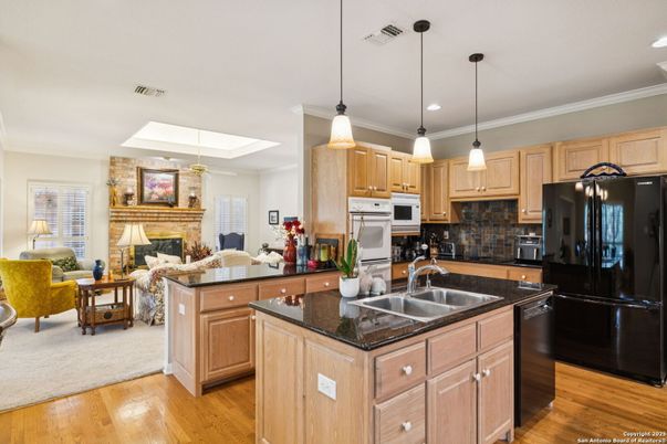 Fireplace, Interior, Kitchen, Living room, Pendant Lights, Recessed Lighting, Stainless Steel Appliances, Wood Texture Flooring