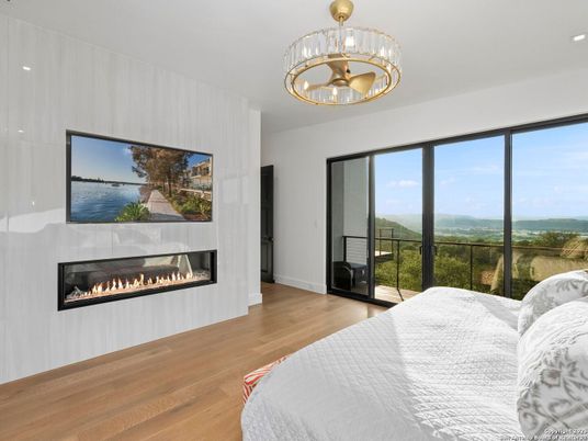 Bedroom, Fireplace, Interior, Pendant Lights, Recessed Lighting, Water, Wood Texture Flooring