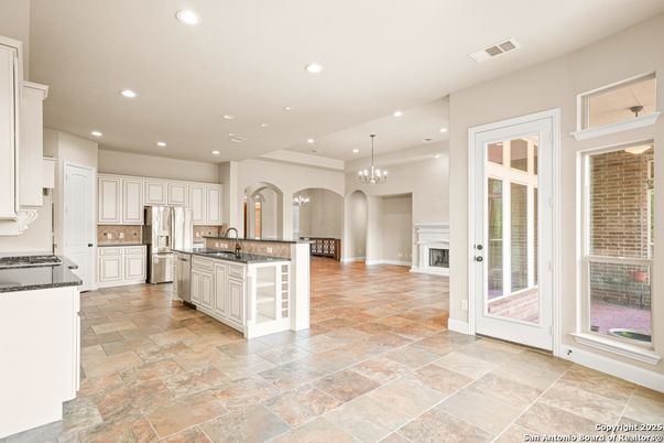 Chandelier, Fireplace, Interior, Kitchen, Pendant Lights, Recessed Lighting, Stainless Steel Appliances