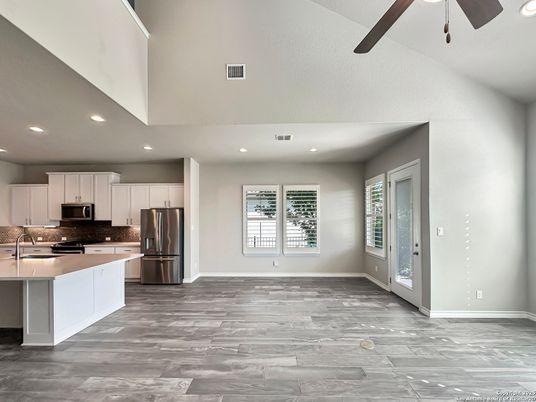 Empty room, Interior, Kitchen, Recessed Lighting, Stainless Steel Appliances, Wood Texture Flooring