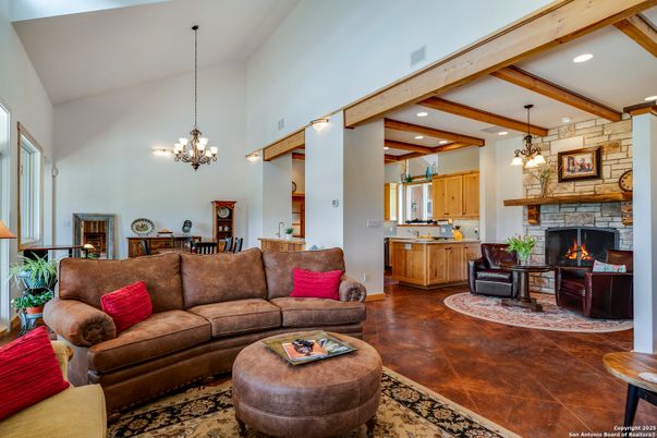Chandelier, Dining room, Fireplace, Interior, Living room, Pendant Lights, Recessed Lighting, Stone Walls, Wooden Beams, Wood Texture Flooring
