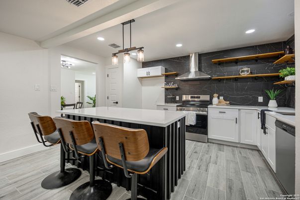 Interior, Kitchen, Marble Walls, Pendant Lights, Recessed Lighting, Stainless Steel Appliances, Wood Texture Flooring