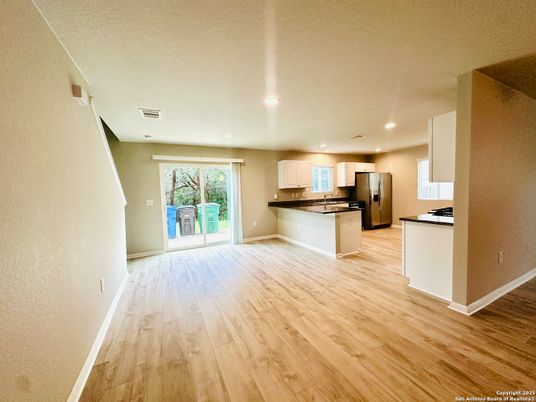 Empty room, Interior, Kitchen, Recessed Lighting, Stainless Steel Appliances, Wood Texture Flooring
