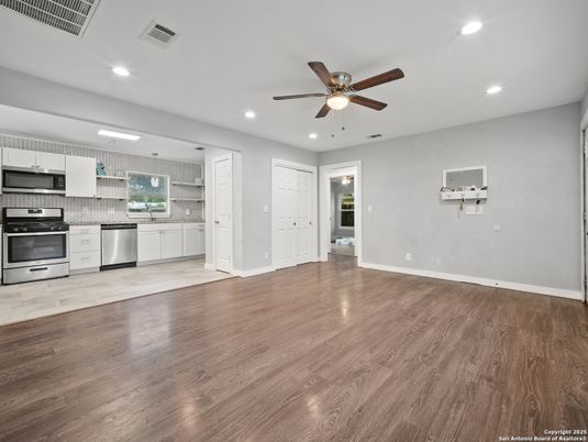 Empty room, Interior, Kitchen, Recessed Lighting, Stainless Steel Appliances, Wood Texture Flooring