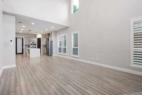 Empty room, Interior, Kitchen, Pendant Lights, Recessed Lighting, Stainless Steel Appliances, Wood Texture Flooring