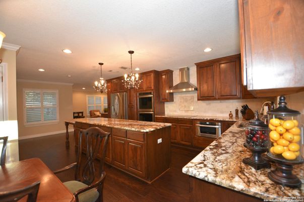 Chandelier, Dining room, Interior, Kitchen, Pendant Lights, Recessed Lighting, Stainless Steel Appliances, Wood Texture Flooring