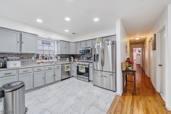 Interior, Kitchen, Marble, Recessed Lighting, Stainless Steel Appliances, Wood Texture Flooring