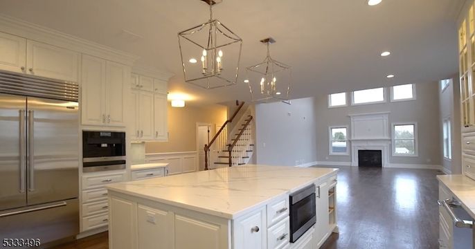 Chandelier, Fireplace, Interior, Kitchen, Pendant Lights, Recessed Lighting, Stainless Steel Appliances, Wood Texture Flooring