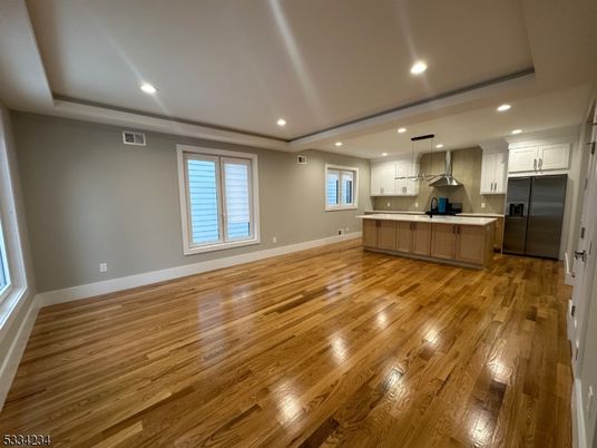 Empty room, Interior, Kitchen, Pendant Lights, Recessed Lighting, Stainless Steel Appliances, Wood Texture Flooring
