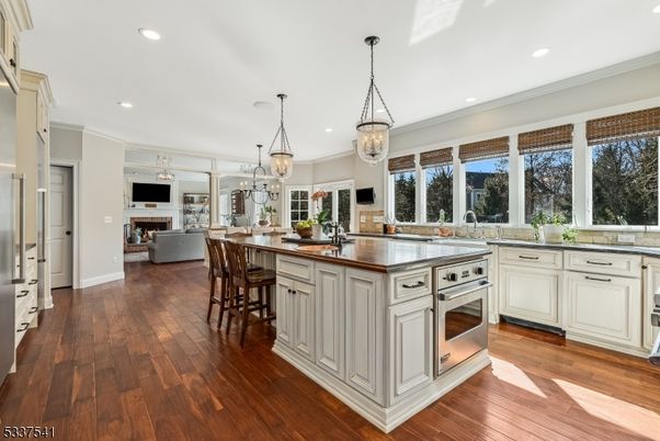 Fireplace, Interior, Kitchen, Living room, Pendant Lights, Recessed Lighting, Stainless Steel Appliances, Wood Texture Flooring