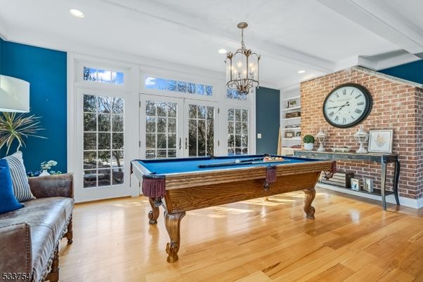 Billiard Table, Chandelier, Game Room, Interior, Recessed Lighting, Stone Walls, Wood Texture Flooring